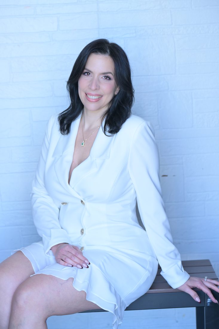 Gissella Rivera seated, smiling
