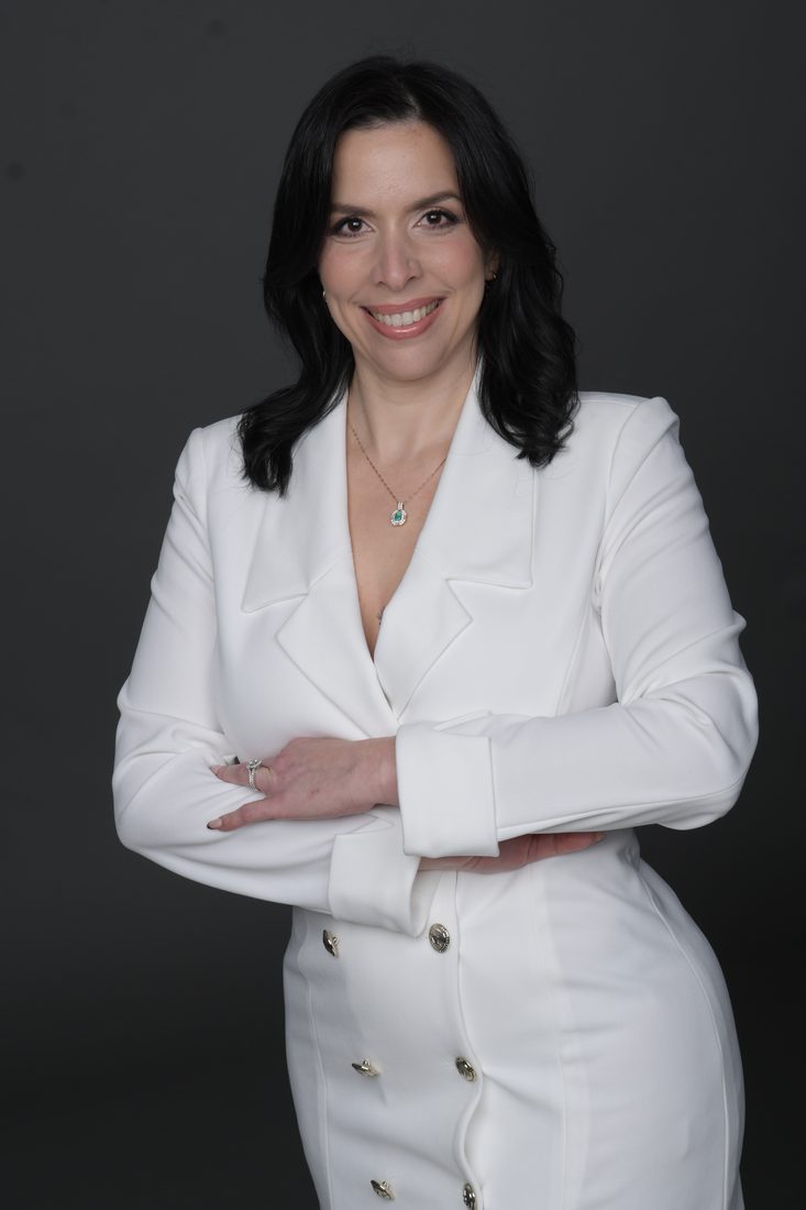 Gissella Rivera, arms crossed, smiling